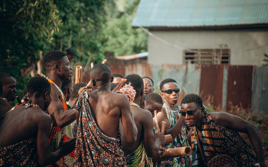 Group of men in traditional clothing performing a cultural dance in Abomey Calavi, Benin.